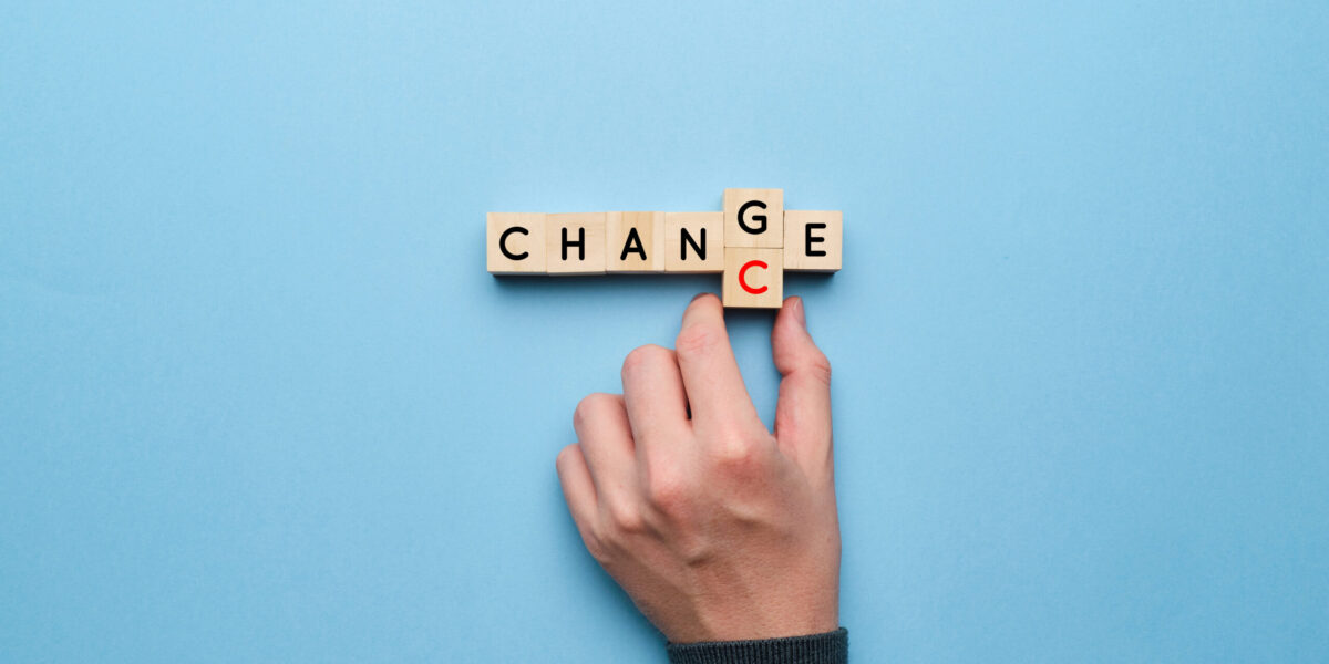 Image intended to articulate change leadership. Wooden blocks spell out the word "change". A woman flips the G to become a C, articulating the chance or opportunity that comes with change.